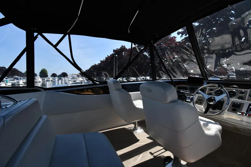  Yacht Photos Pics Interior of 2003 Regal Commodore 3880 yacht with helm and seating, marina view.