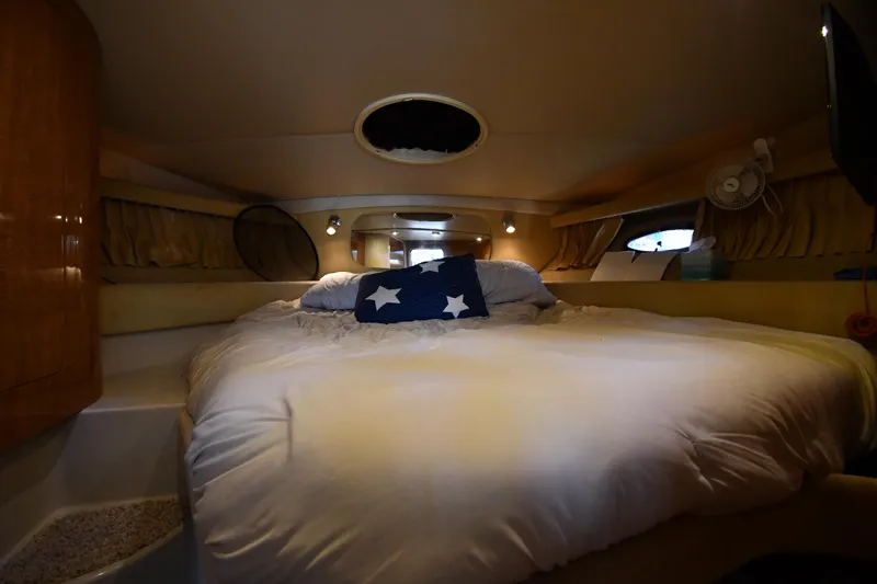  Yacht Photos Pics Cozy cabin interior of 2003 Regal Commodore 3880 yacht with plush bedding.