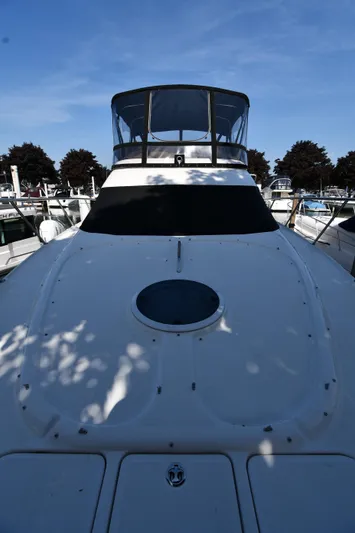  Yacht Photos Pics 2003 Regal Commodore 3880 yacht docked under clear blue sky.