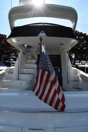  Yacht Photos Pics 2003 Regal Commodore 3880 yacht with American flag, rear view, sunny day.