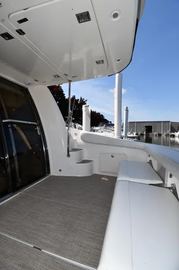  Yacht Photos Pics 2003 Regal Commodore 3880 yacht deck with seating, docked at marina under clear sky.