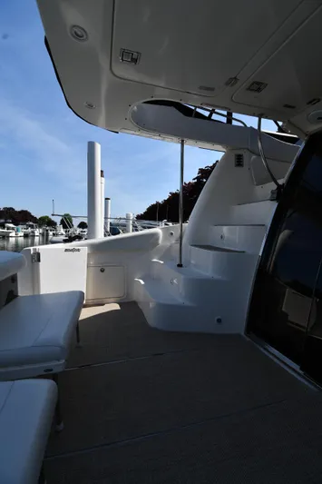  Yacht Photos Pics 2003 Regal Commodore 3880 yacht interior with seating and steps, docked under clear sky.