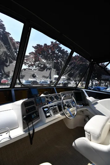  Yacht Photos Pics Interior view of 2003 Regal Commodore 3880 yacht cockpit with steering wheel and control panel.