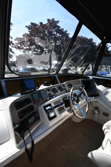  Yacht Photos Pics Helm of 2003 Regal Commodore 3880 yacht with steering wheel and navigation instruments.