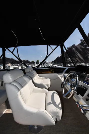 Yacht Photos Pics 2003 Regal Commodore 3880 yacht interior with white leather seats and steering wheel.