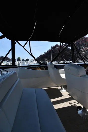  Yacht Photos Pics Interior view of 2003 Regal Commodore 3880 yacht with white seating and marina backdrop.