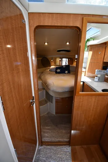  Yacht Photos Pics Interior of 2003 Regal Commodore 3880 yacht, featuring cozy bedroom and wooden finishes.