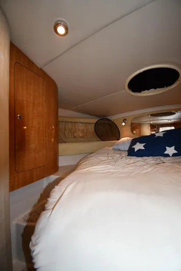  Yacht Photos Pics Interior cabin of 2003 Regal Commodore 3880 yacht with cozy bed and wooden accents.