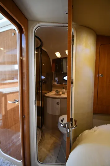  Yacht Photos Pics 2003 Regal Commodore 3880 yacht interior, featuring a compact bathroom with wooden accents.