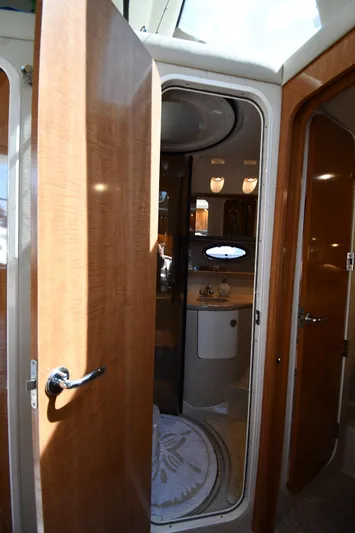  Yacht Photos Pics Interior view of 2003 Regal Commodore 3880 yacht bathroom with wooden doors and modern fixtures.