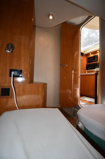  Yacht Photos Pics Interior of 2003 Regal Commodore 3880 yacht, featuring wood paneling and cozy cabin space.