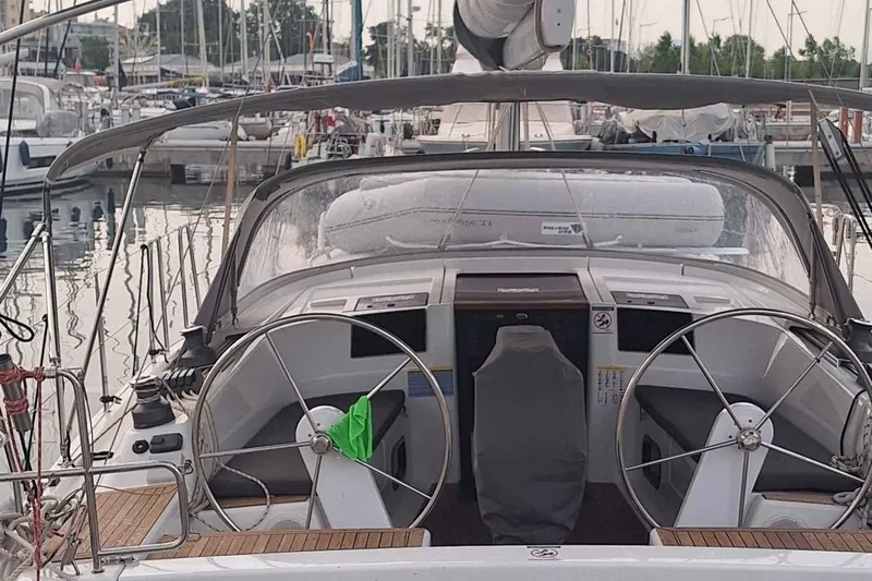  Yacht Photos Pics 2014 Hanse 385 sailboat cockpit with dual steering wheels in a marina setting.