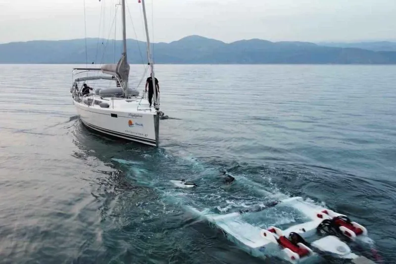  Yacht Photos Pics Sailing yacht Hanse 385 (2014) on calm waters with a submerged device behind.