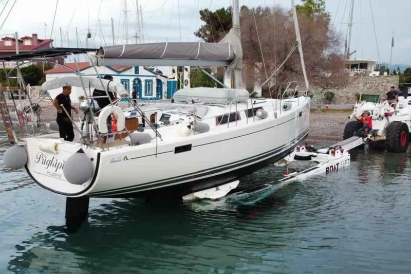  Yacht Photos Pics 2014 Hanse 385 sailboat being launched into water using a boat lift.