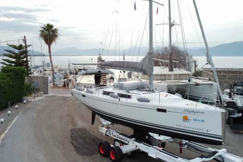  Yacht Photos Pics 2014 Hanse 385 sailboat on trailer at marina, with scenic waterfront background.