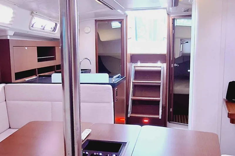  Yacht Photos Pics Interior of 2014 Hanse 385 yacht, featuring modern wood finishes and cozy seating area.