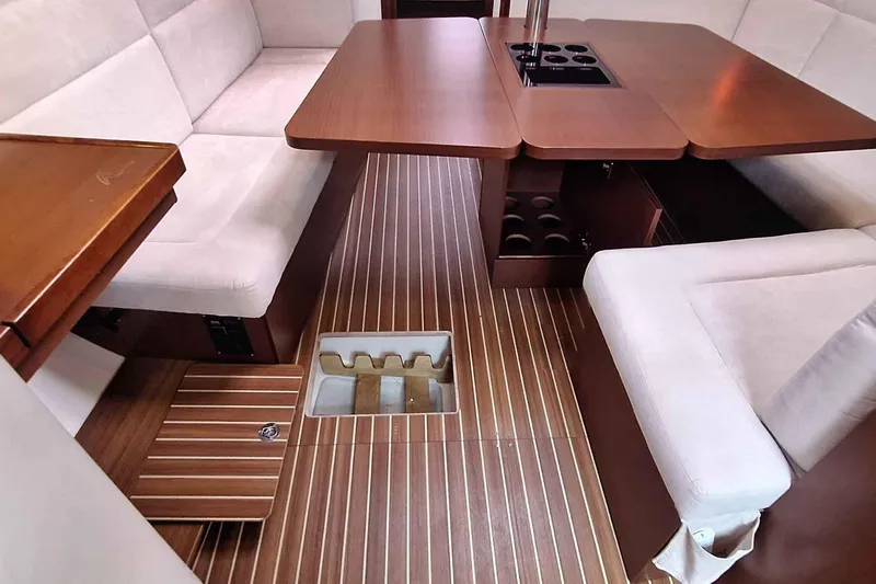  Yacht Photos Pics Interior of 2014 Hanse 385 yacht with wooden flooring and cushioned seating.