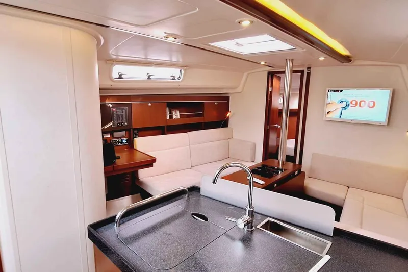  Yacht Photos Pics Luxurious interior of 2014 Hanse 385 yacht with modern kitchen and seating area.