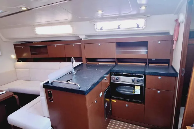  Yacht Photos Pics Luxurious interior of 2014 Hanse 385 yacht with modern kitchen and seating area.