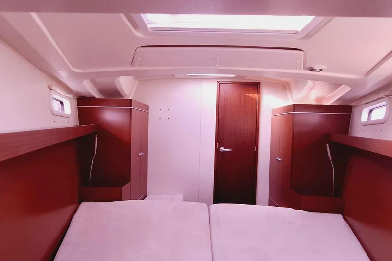  Yacht Photos Pics Interior of 2014 Hanse 385 yacht cabin with wooden cabinets and cozy bed.