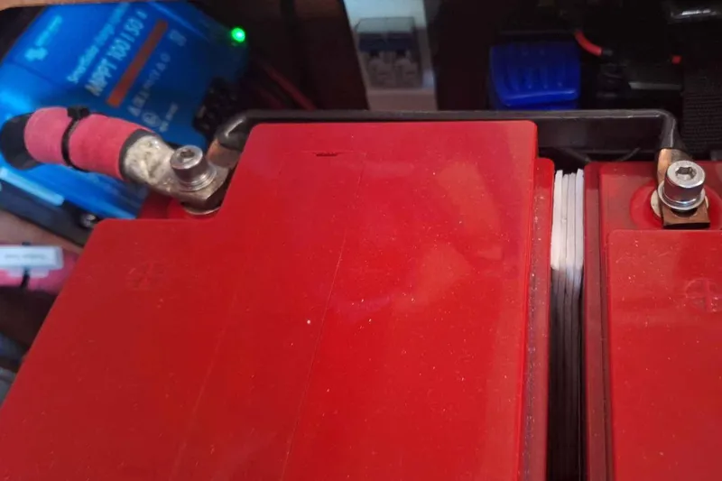  Yacht Photos Pics Red battery setup in a 2014 Hanse 385 sailboat, featuring connected terminals.