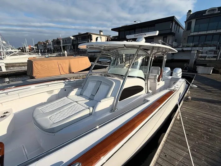  Yacht Photos Pics 2026 Mag Bay 38 CC boat docked, featuring sleek design and spacious seating.