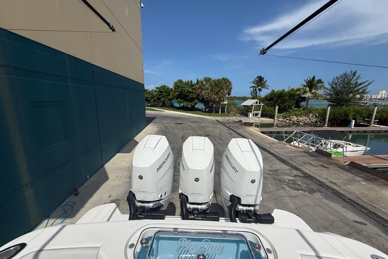  Yacht Photos Pics 2026 Mag Bay 38 CC with triple Mercury outboards at a marina dock.