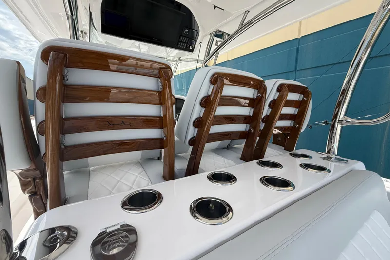  Yacht Photos Pics 2026 Mag Bay 38 CC boat interior with wooden seats and cup holders.