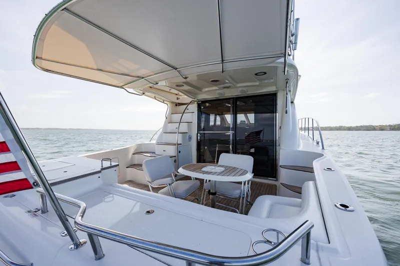 Beautiful Blue Yacht Photos Pics 2008 Sea Ray 52 Sedan Bridge yacht with spacious deck and seating area on the water.