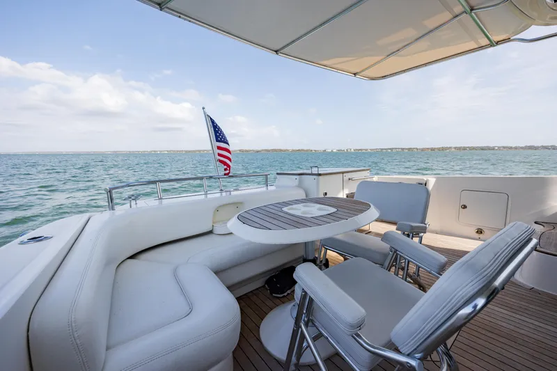 Beautiful Blue Yacht Photos Pics 2008 Sea Ray 52 Sedan Bridge yacht deck with seating, table, and ocean view.