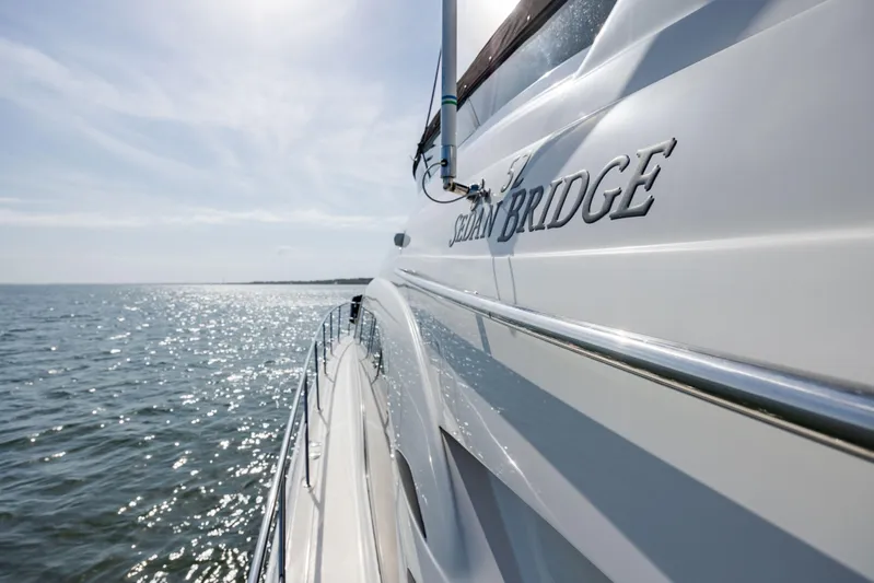 Beautiful Blue Yacht Photos Pics 2008 Sea Ray 52 Sedan Bridge yacht cruising on open water under a clear sky.