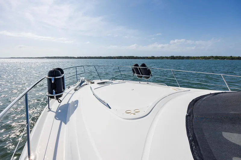 Beautiful Blue Yacht Photos Pics 2008 Sea Ray 52 Sedan Bridge yacht cruising on open water under clear skies.
