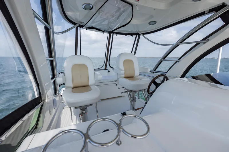 Beautiful Blue Yacht Photos Pics 2008 Sea Ray 52 Sedan Bridge interior with ocean view, featuring modern helm and seating.