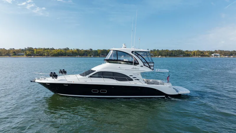 Beautiful Blue Yacht Photos Pics 2008 Sea Ray 52 Sedan Bridge yacht on calm water under blue sky.