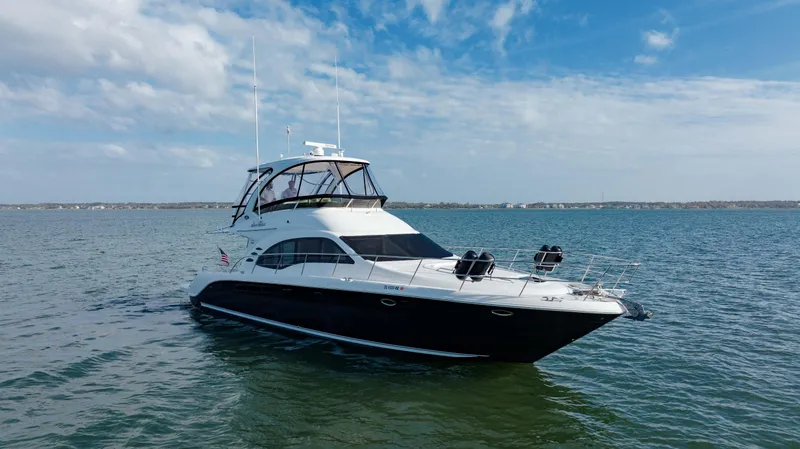 Beautiful Blue Yacht Photos Pics 2008 Sea Ray 52 Sedan Bridge yacht cruising on open water under a blue sky.