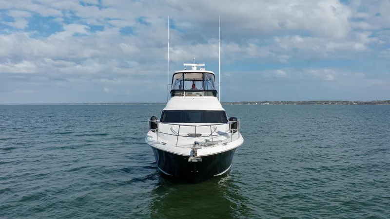 Beautiful Blue Yacht Photos Pics 2008 Sea Ray 52 Sedan Bridge yacht on open water under cloudy sky.