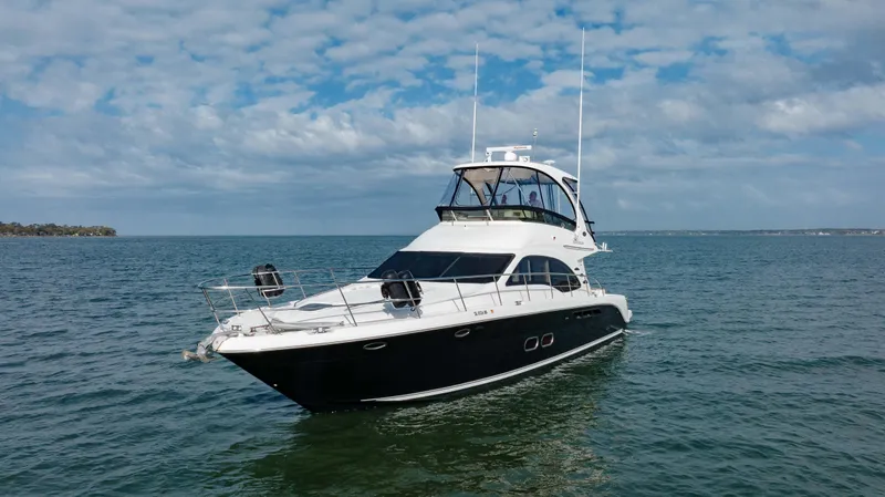 Beautiful Blue Yacht Photos Pics 2008 Sea Ray 52 Sedan Bridge yacht cruising on open water under a cloudy sky.