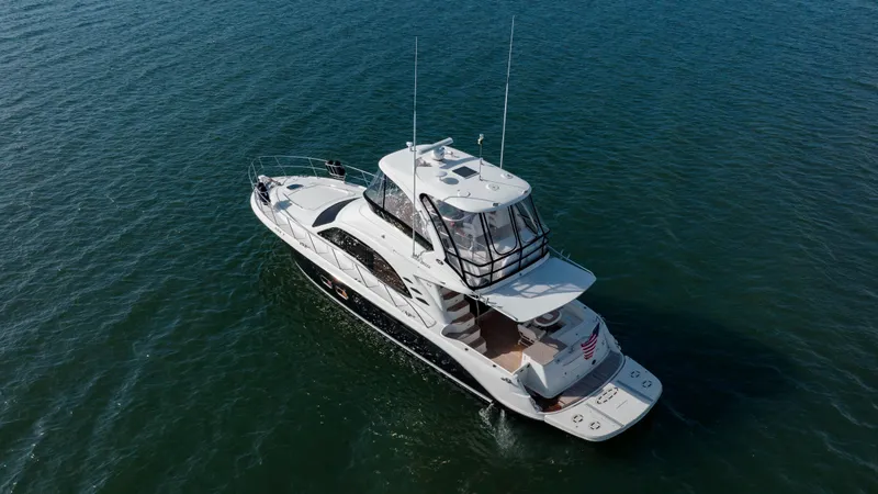Beautiful Blue Yacht Photos Pics 2008 Sea Ray 52 Sedan Bridge yacht cruising on open water.