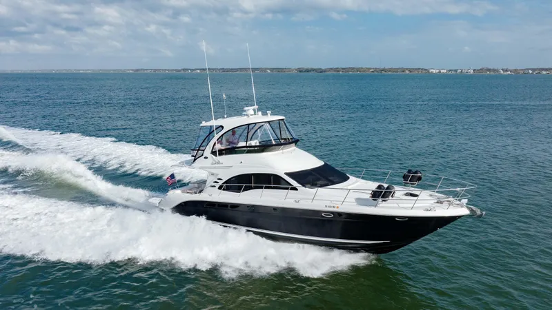 Beautiful Blue Yacht Photos Pics 2008 Sea Ray 52 Sedan Bridge yacht cruising on open water.