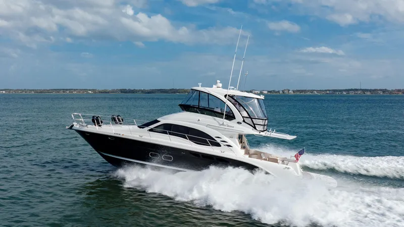 Beautiful Blue Yacht Photos Pics 2008 Sea Ray 52 Sedan Bridge yacht cruising on open water under a clear sky.