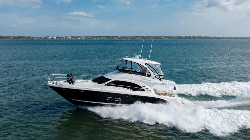 Beautiful Blue Yacht Photos Pics 2008 Sea Ray 52 Sedan Bridge yacht cruising on open water.