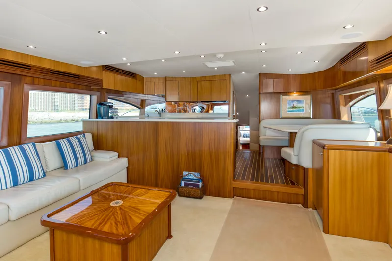Refuge Yacht Photos Pics Luxurious interior of 2007 Hatteras 68 Enclosed Bridge yacht with elegant wood finishes.