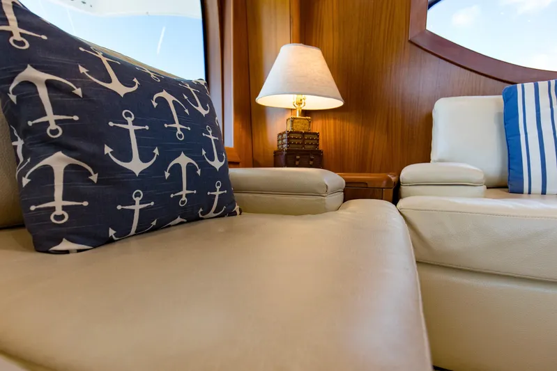 Refuge Yacht Photos Pics Luxurious interior of 2007 Hatteras 68 Enclosed Bridge yacht with nautical-themed decor.
