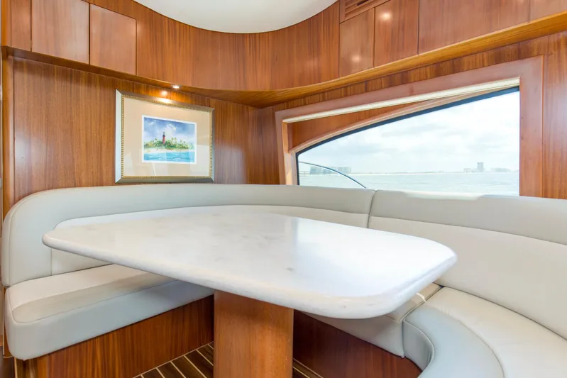 Refuge Yacht Photos Pics Luxurious interior of 2007 Hatteras 68 Enclosed Bridge yacht with elegant dining area.