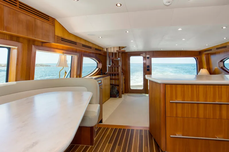 Refuge Yacht Photos Pics Luxurious interior of 2007 Hatteras 68 Enclosed Bridge yacht with ocean view.