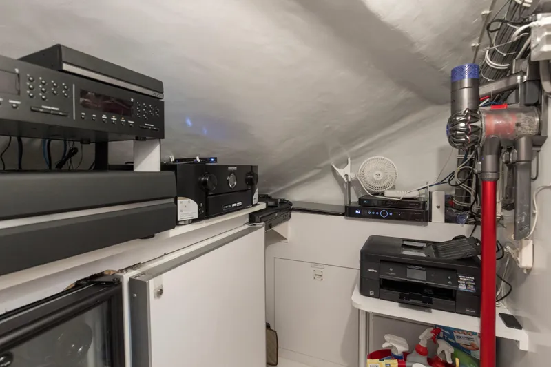 Refuge Yacht Photos Pics Electronics and cleaning supplies in a 2007 Hatteras 68 Enclosed Bridge yacht interior.