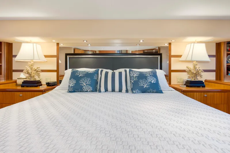 Refuge Yacht Photos Pics Luxurious bedroom interior of 2007 Hatteras 68 Enclosed Bridge yacht with elegant decor.