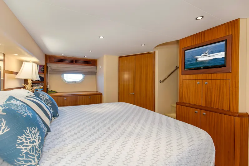 Refuge Yacht Photos Pics Luxurious bedroom interior of 2007 Hatteras 68 Enclosed Bridge yacht with elegant wood finishes.