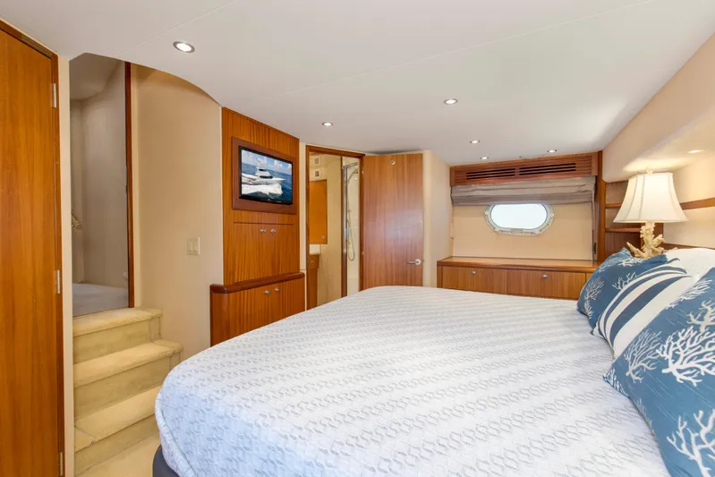 Refuge Yacht Photos Pics Luxurious bedroom interior of 2007 Hatteras 68 Enclosed Bridge yacht with elegant wood finishes.