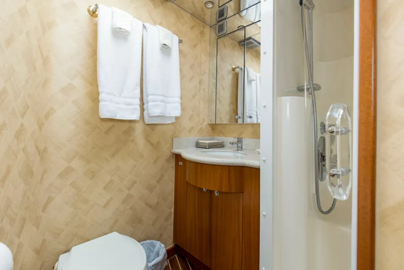 Refuge Yacht Photos Pics Luxurious bathroom on 2007 Hatteras 68 Enclosed Bridge yacht with shower and towels.